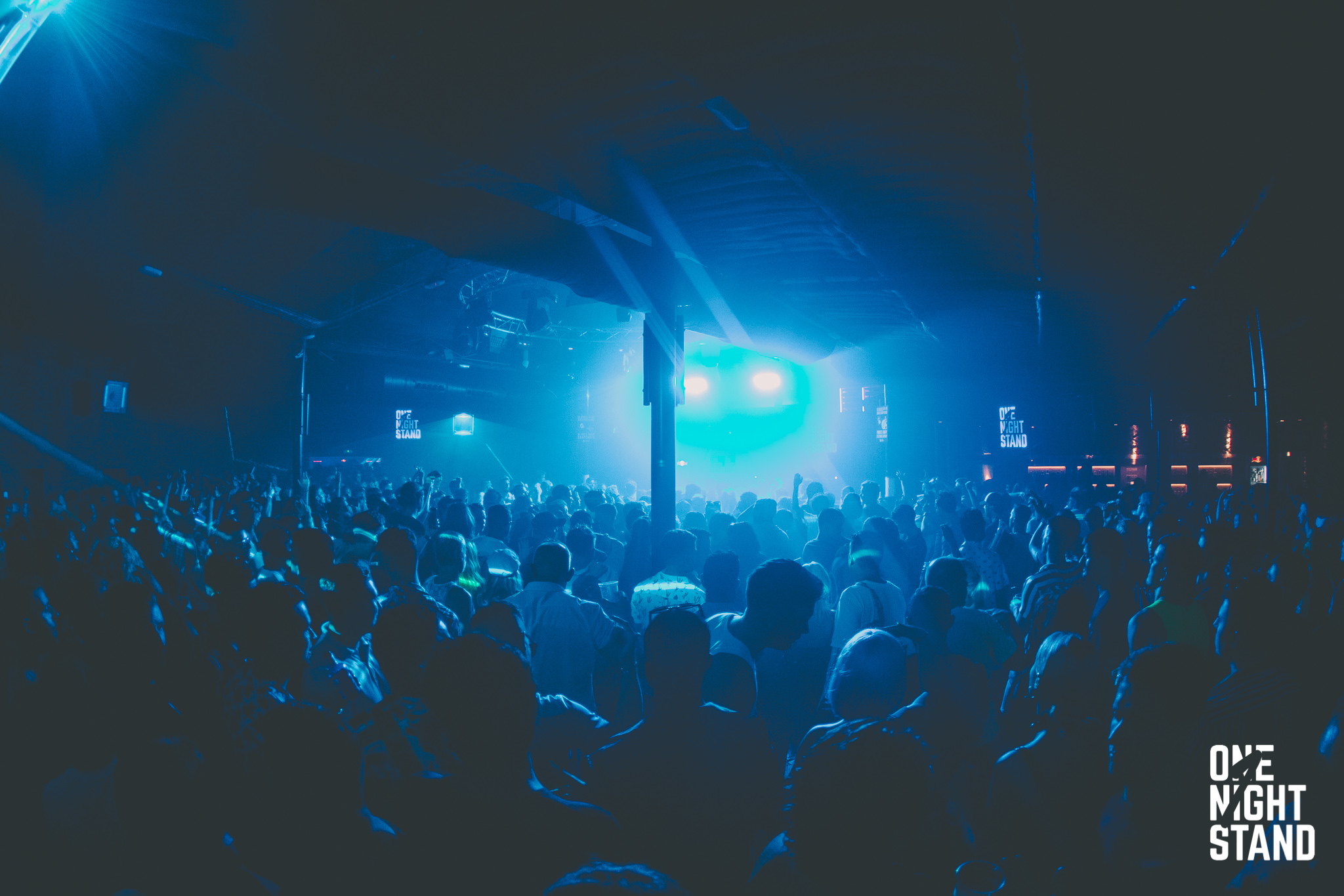 One Night Stand event crowd bathed in blue light